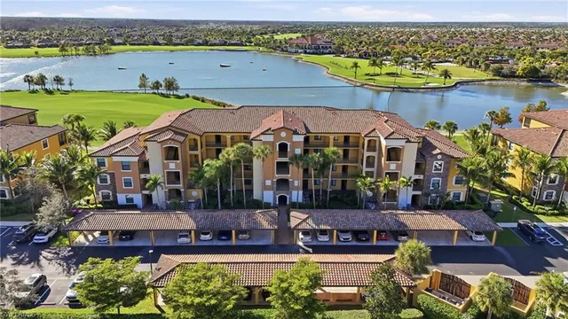 an aerial view of a house with a garden and lake view