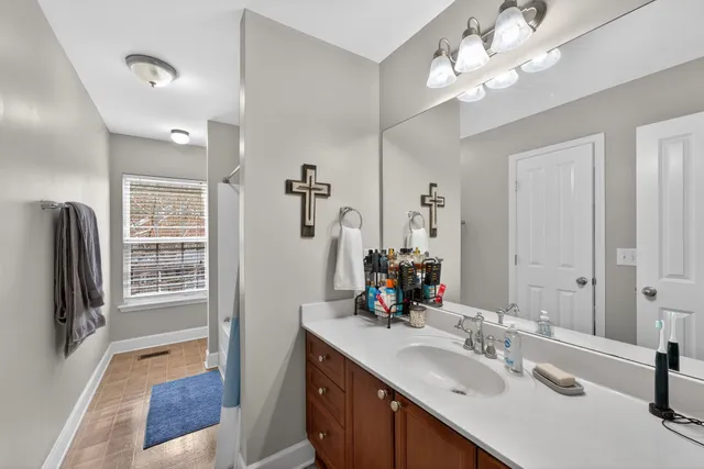 a bathroom with a sink double vanity granite tub and shower