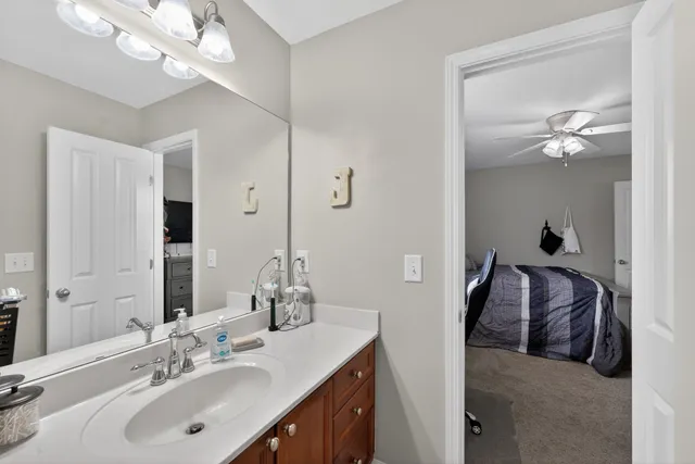 a en suite bathroom with a double vanity sink and a mirror