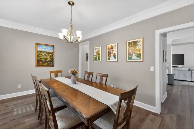 a view of a dining room with furniture wooden floor and a chandelier