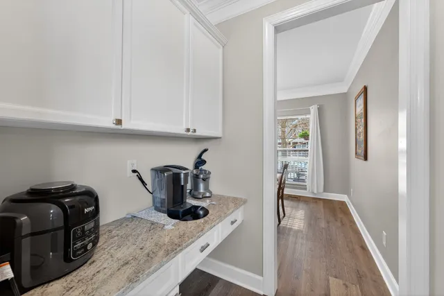 a kitchen with granite countertop a stove and a wooden floor