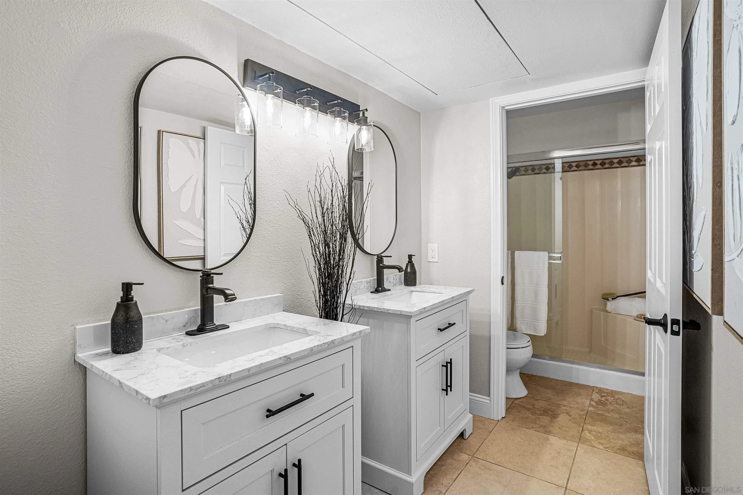 3926 Voltaire Street San Diego, CA 92107 - Photo 12 of 30 a bathroom with a double vanity sink and a mirror