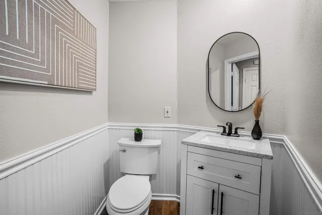a bathroom with a toilet sink and mirror