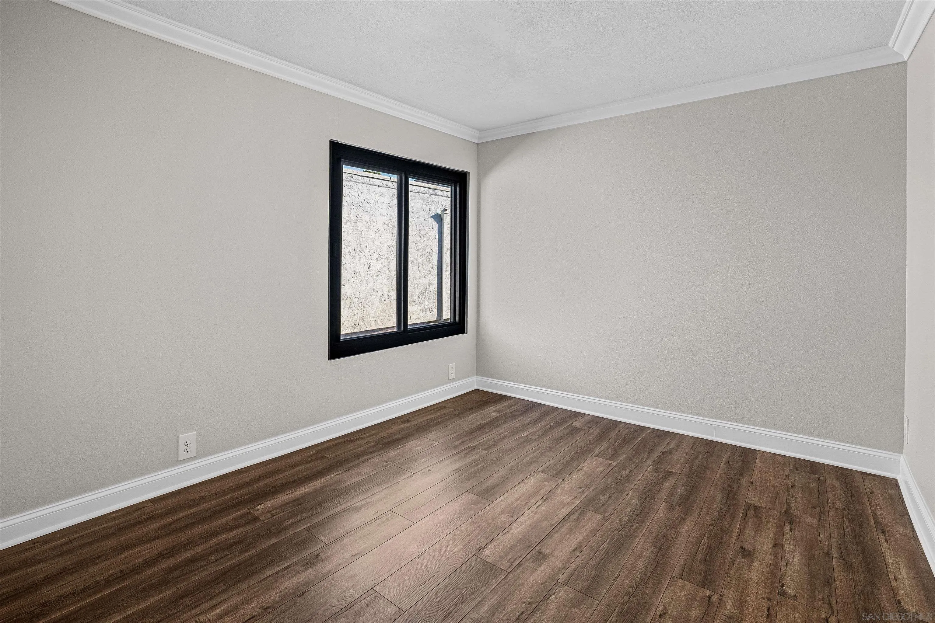 3926 Voltaire Street San Diego, CA 92107 - Photo 14 of 30 a view of an empty room with wooden floor and a window
