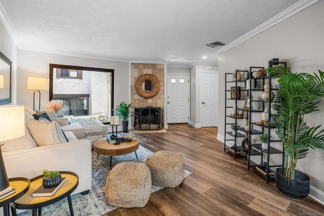 a living room with fireplace furniture and a large window