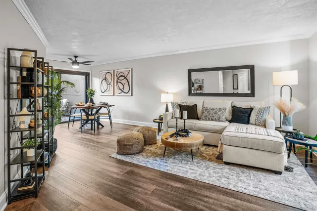 a living room with furniture and a wooden floor