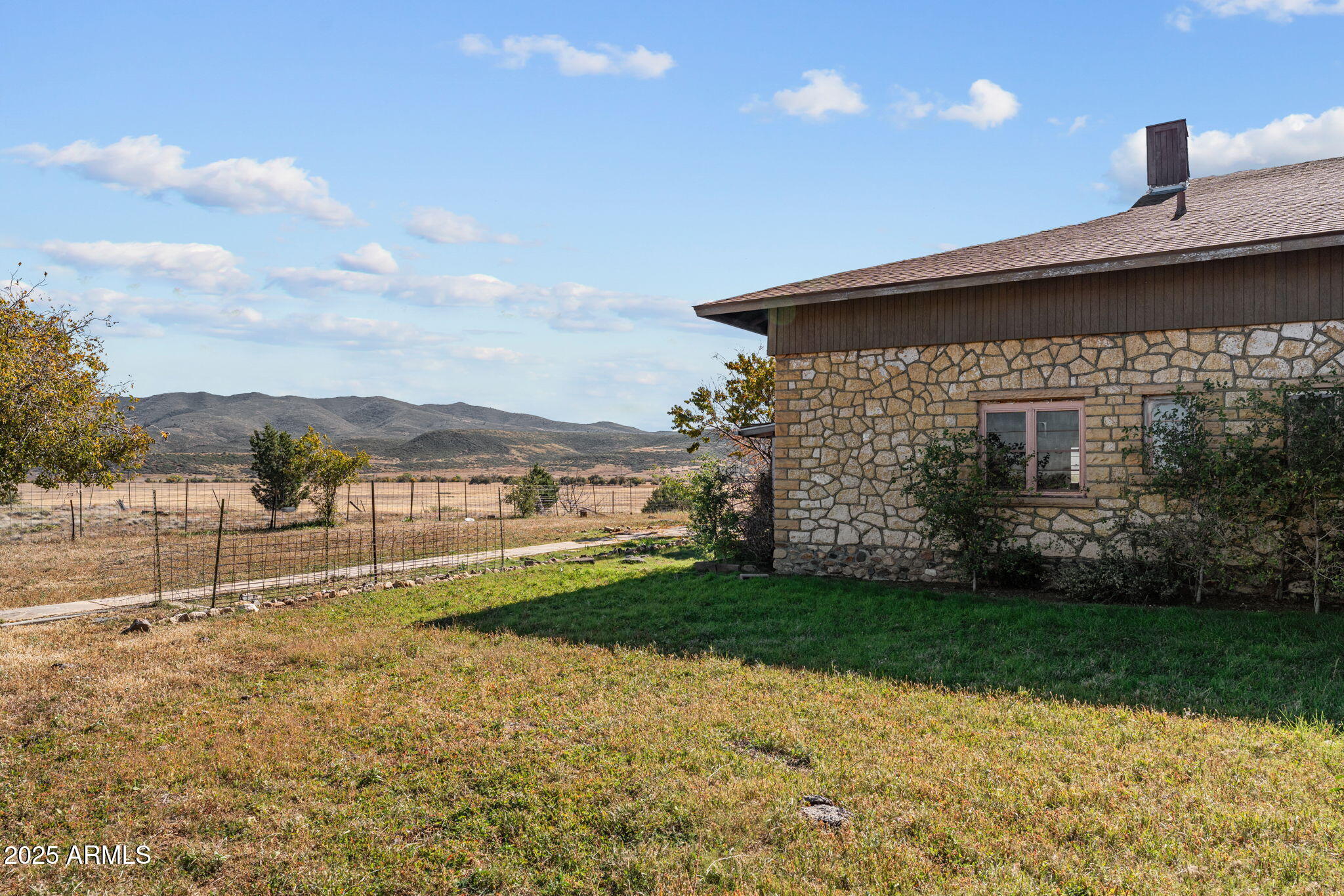 16057 Sickles Ranch Road Peeples Valley, AZ 86332 - Photo 27 of 39 a view of a house with a yard
