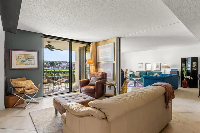 a living room with furniture and a floor to ceiling window