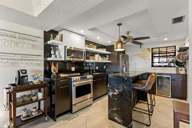 a kitchen with stainless steel appliances granite countertop a stove and a refrigerator