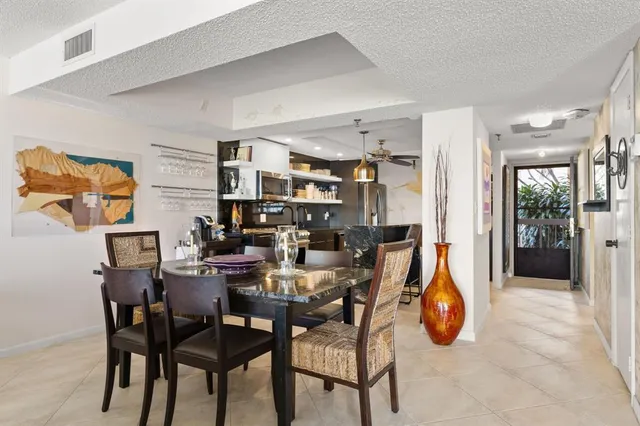 a view of a dining room with furniture and a chandelier