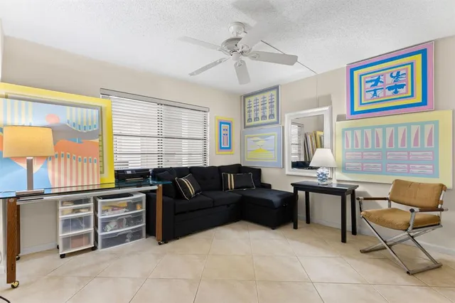 a living room with furniture a desk and chair with wooden floor