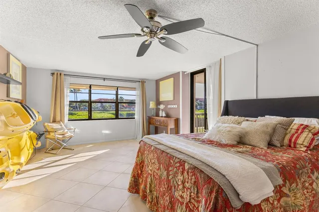 a bedroom with a large bed and a large window