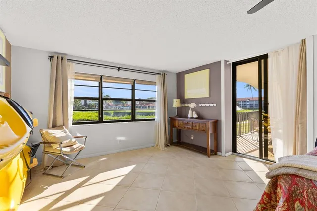 a living room with furniture and large windows