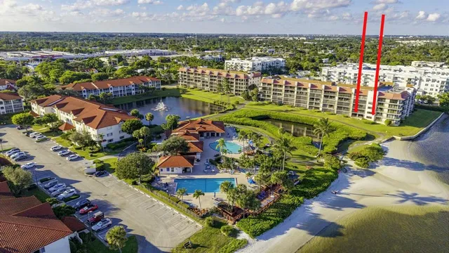 an aerial view of residential houses with outdoor space and swimming pool