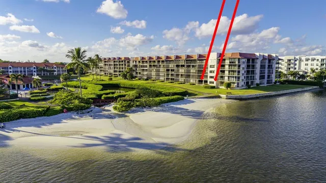 a view of swimming pool of water with lawn chairs and lake view