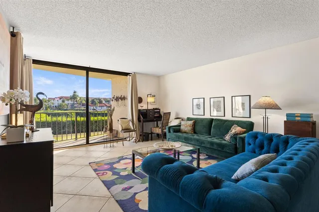 a living room with furniture and a floor to ceiling window