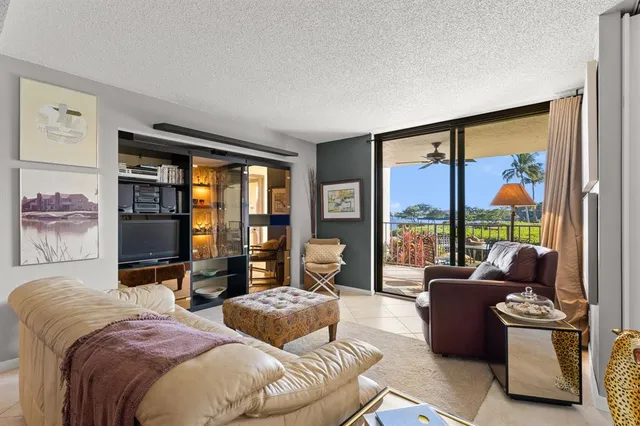 a bedroom with furniture and a large window