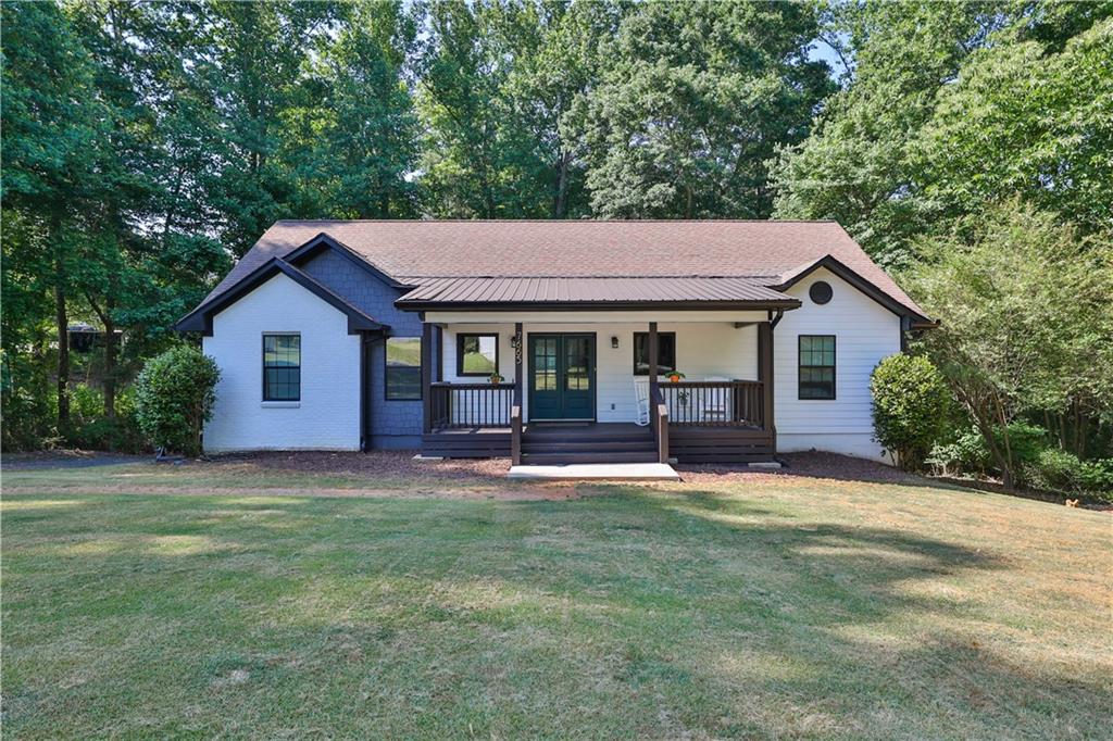 7665 Campground Road Cumming, GA 30040 - Photo 1 of 1 a front view of a house with a garden