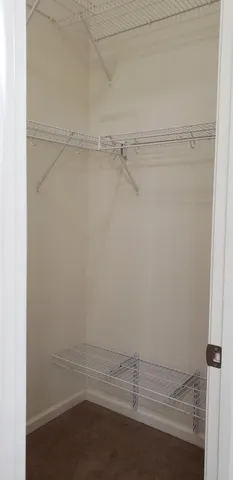 a view of a hallway view with wooden floor and staircase