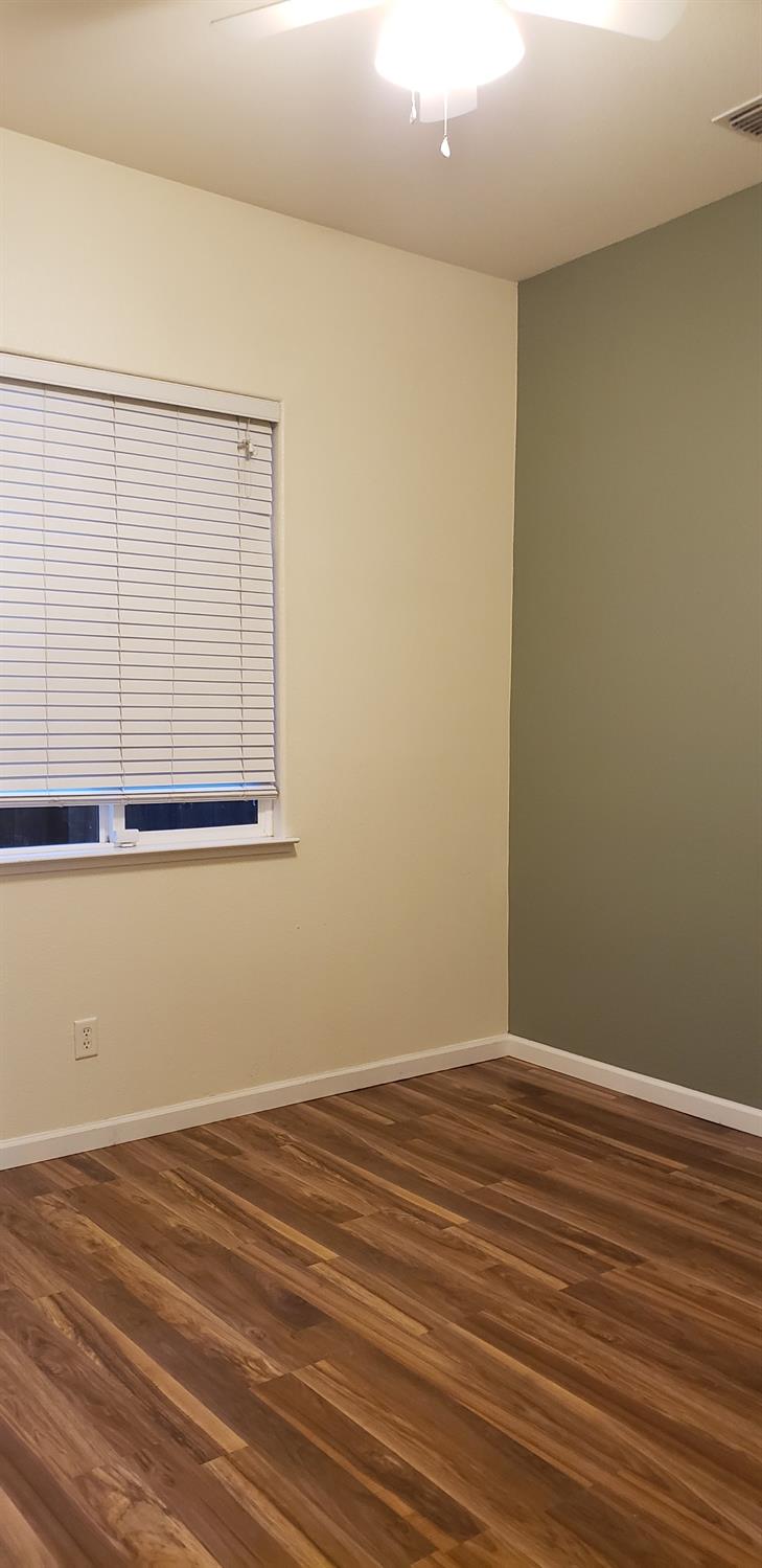 10726 Irene Way Live Oak, CA 95953 - Photo 17 of 50 an empty room with wooden floor and windows