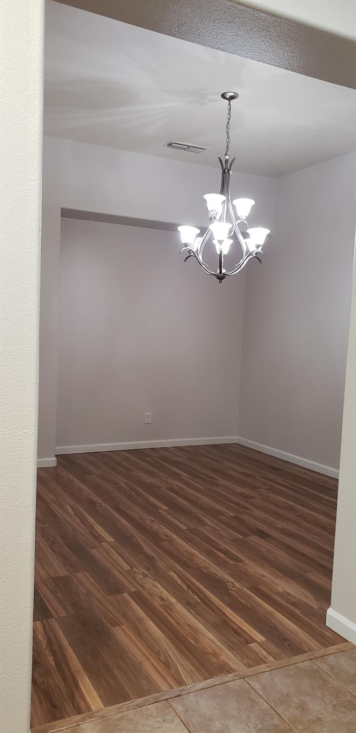 10726 Irene Way Live Oak, CA 95953 - Photo 26 of 50 a view of a chandelier in big room with wooden floor