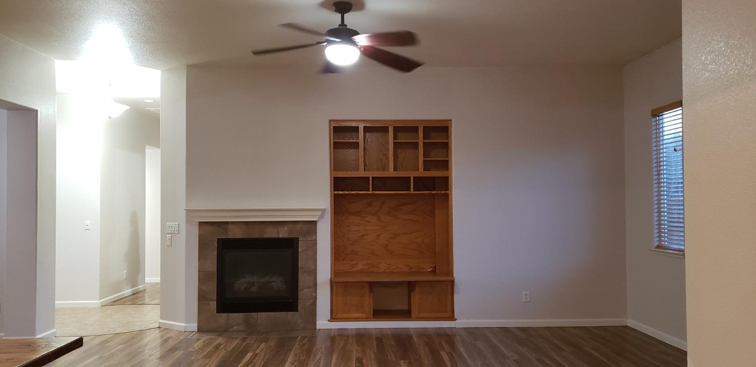 10726 Irene Way Live Oak, CA 95953 - Photo 32 of 50 a view of a livingroom with a fireplace and wooden floor