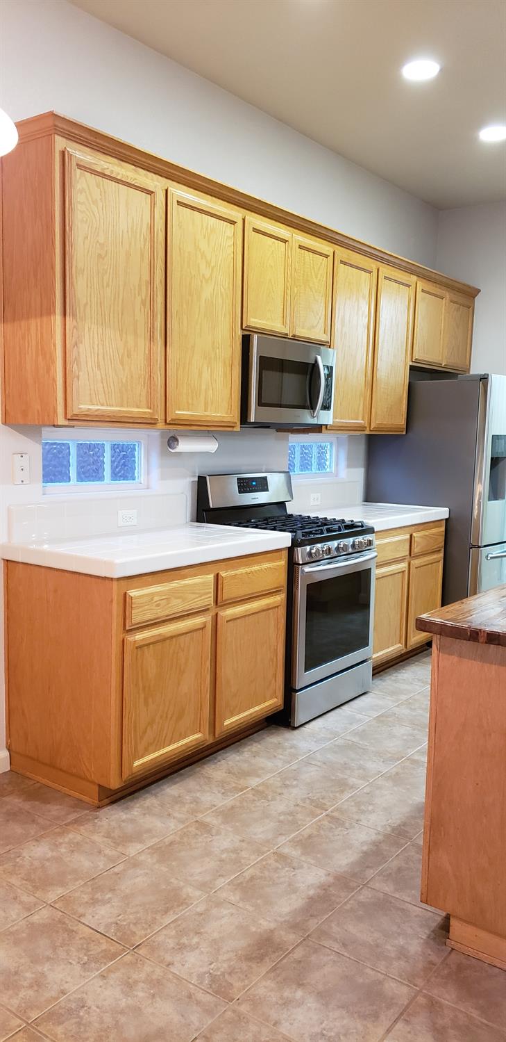 10726 Irene Way Live Oak, CA 95953 - Photo 35 of 50 a kitchen with stainless steel appliances granite countertop a stove a sink and a microwave