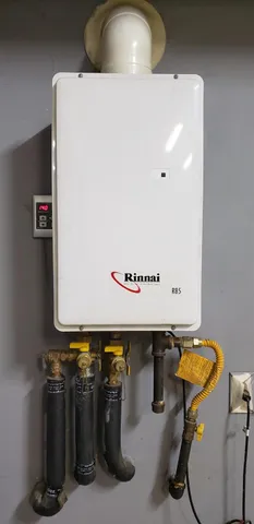 a view of an empty room with closet and a window