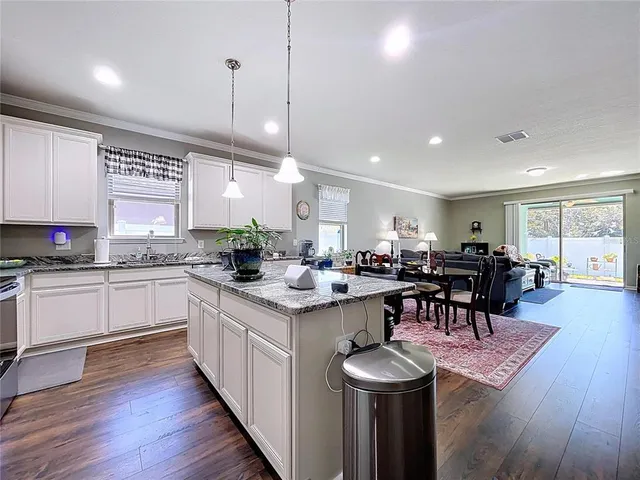 a kitchen with lots of counter top space and dining table