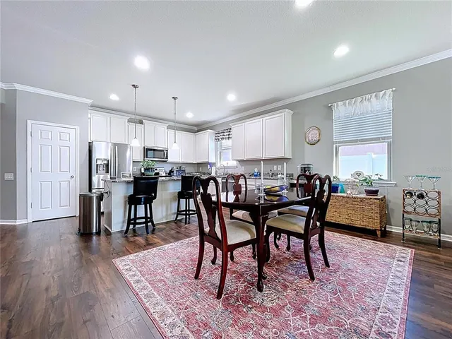 a view of a dining room with furniture and wooden floor