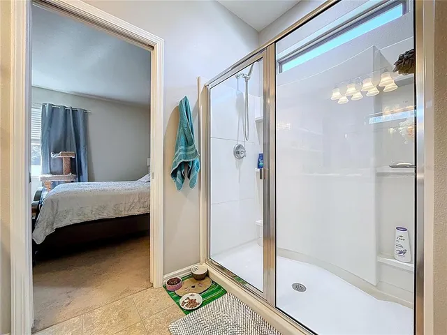 a bedroom with a bed and a mirror