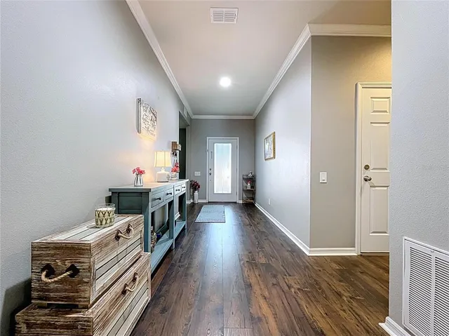 a view of a hallway with wooden floor