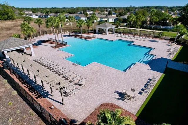 an aerial view of a swimming pool with a patio