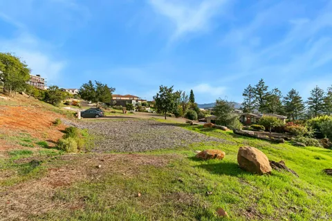 a view of a town with barn and trees