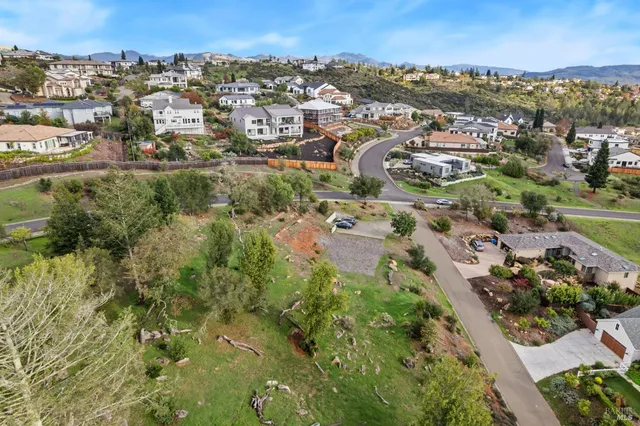 an aerial view of residential house with outdoor space and trees all around