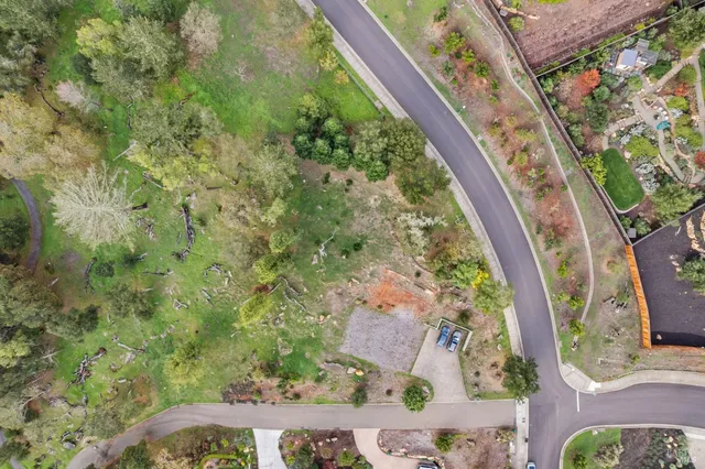 an aerial view of a residential houses with outdoor space