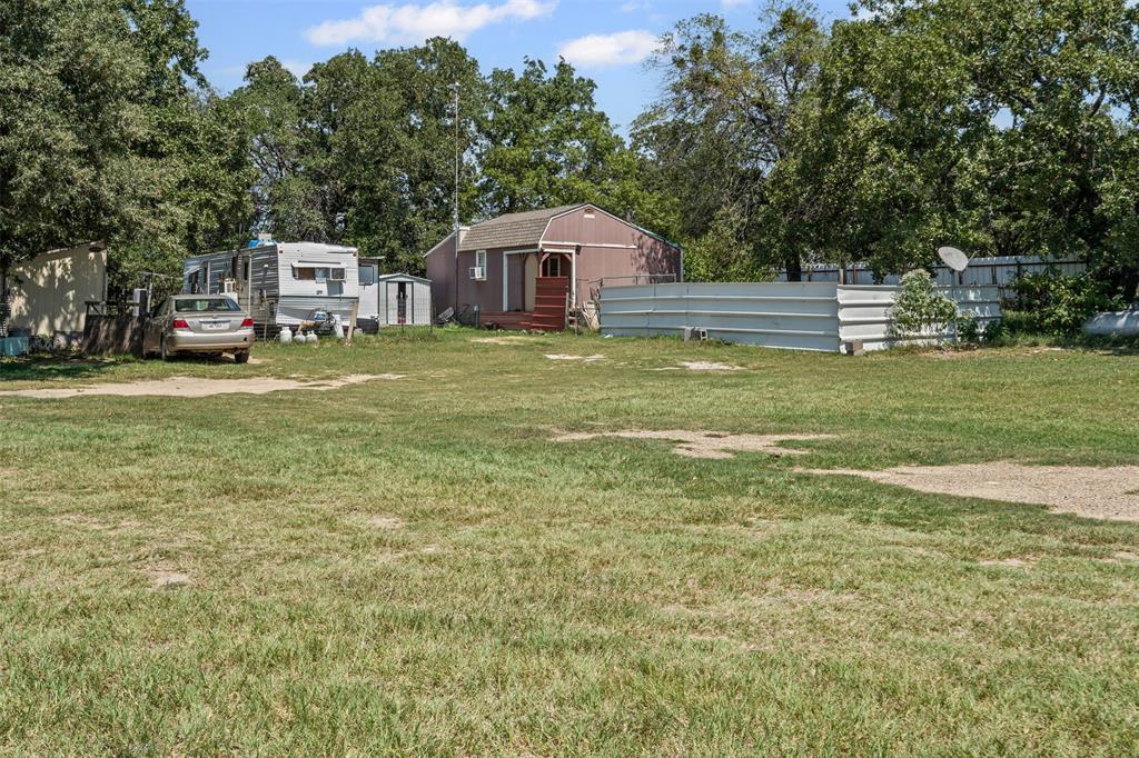 3100 Sarra Lane Springtown, TX 76082 - Photo 12 of 40 a front view of a house with a garden