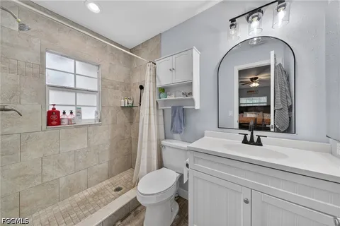 a bathroom with a sink toilet and shower