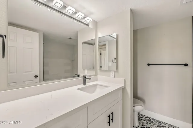 a bathroom with a sink and a mirror with bathtub
