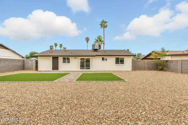 a aerial view of a house next to a yard