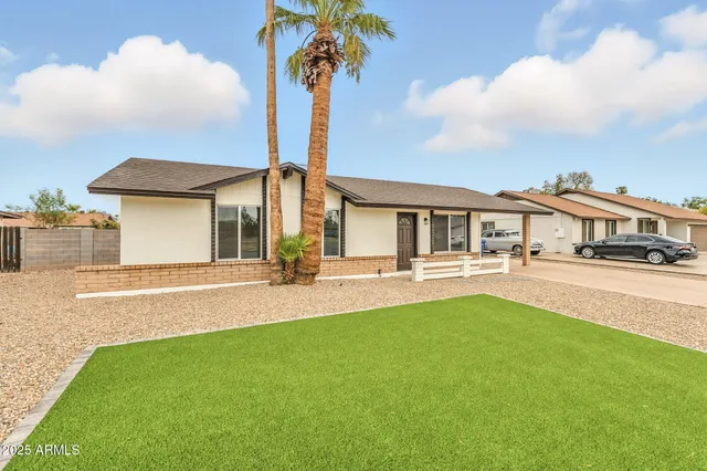a front view of a house with swimming pool having outdoor seating