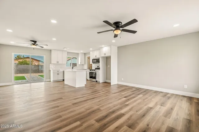 a view of a kitchen with wooden floor and a kitchen