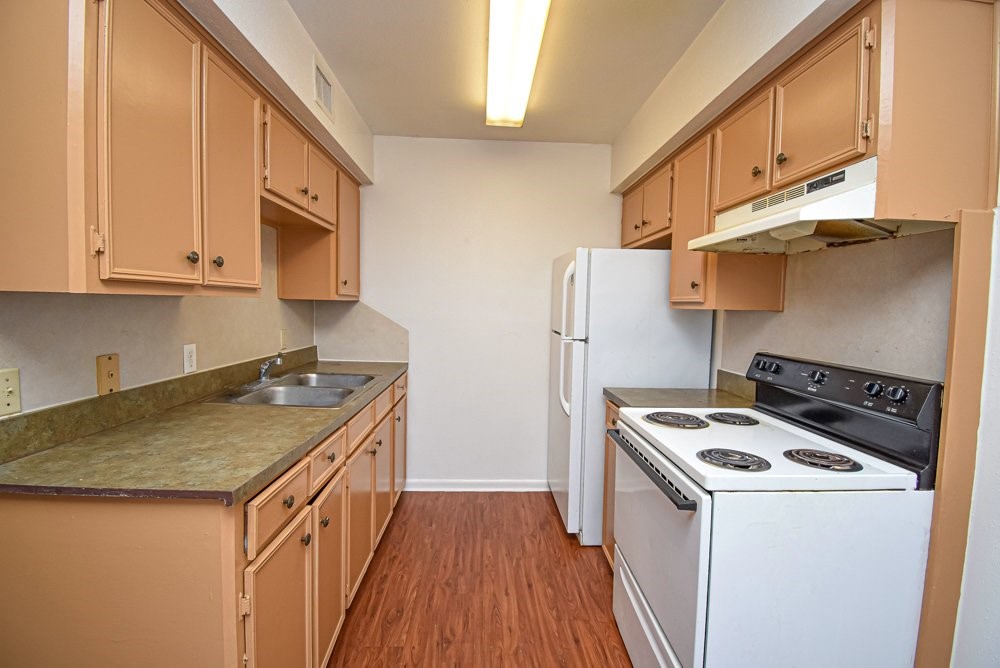 20 South Mechanic Street Bellville, TX 77418 - Photo 7 of 8 a kitchen with stainless steel appliances granite countertop a sink stove and refrigerator
