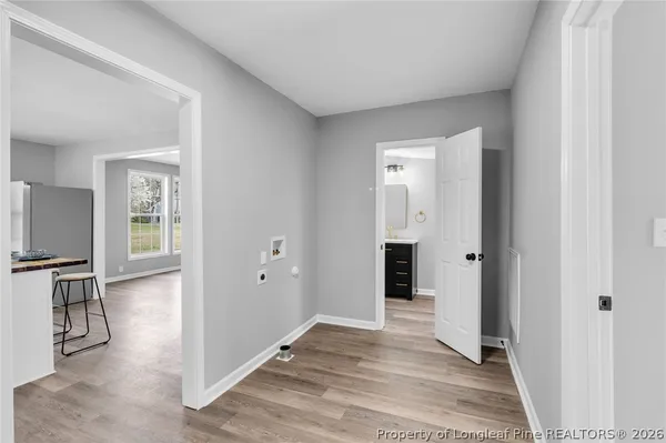 a view of a livingroom with wooden floor and windows