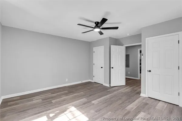 a view of empty room with wooden floor