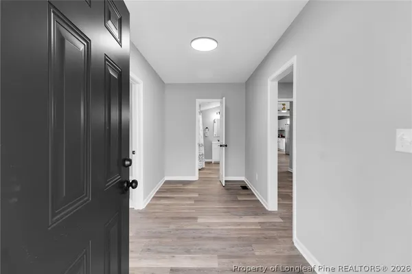a view of a hallway with wooden floor