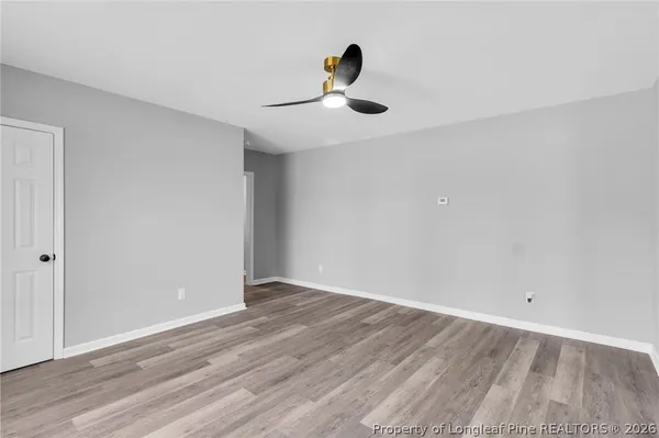a view of empty room with wooden floor