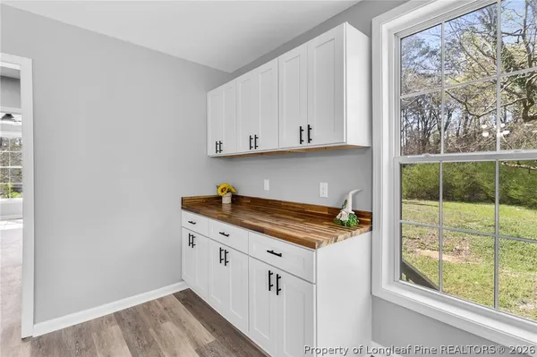 a kitchen with granite countertop a sink and a stove next to a window