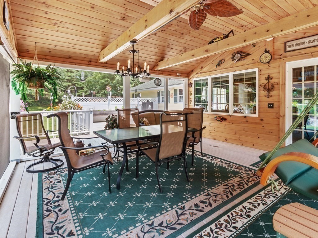 39 Fitzgerald Road Charlton, MA 01507 - Photo 15 of 37 a view of a patio with table and chairs and wooden floor