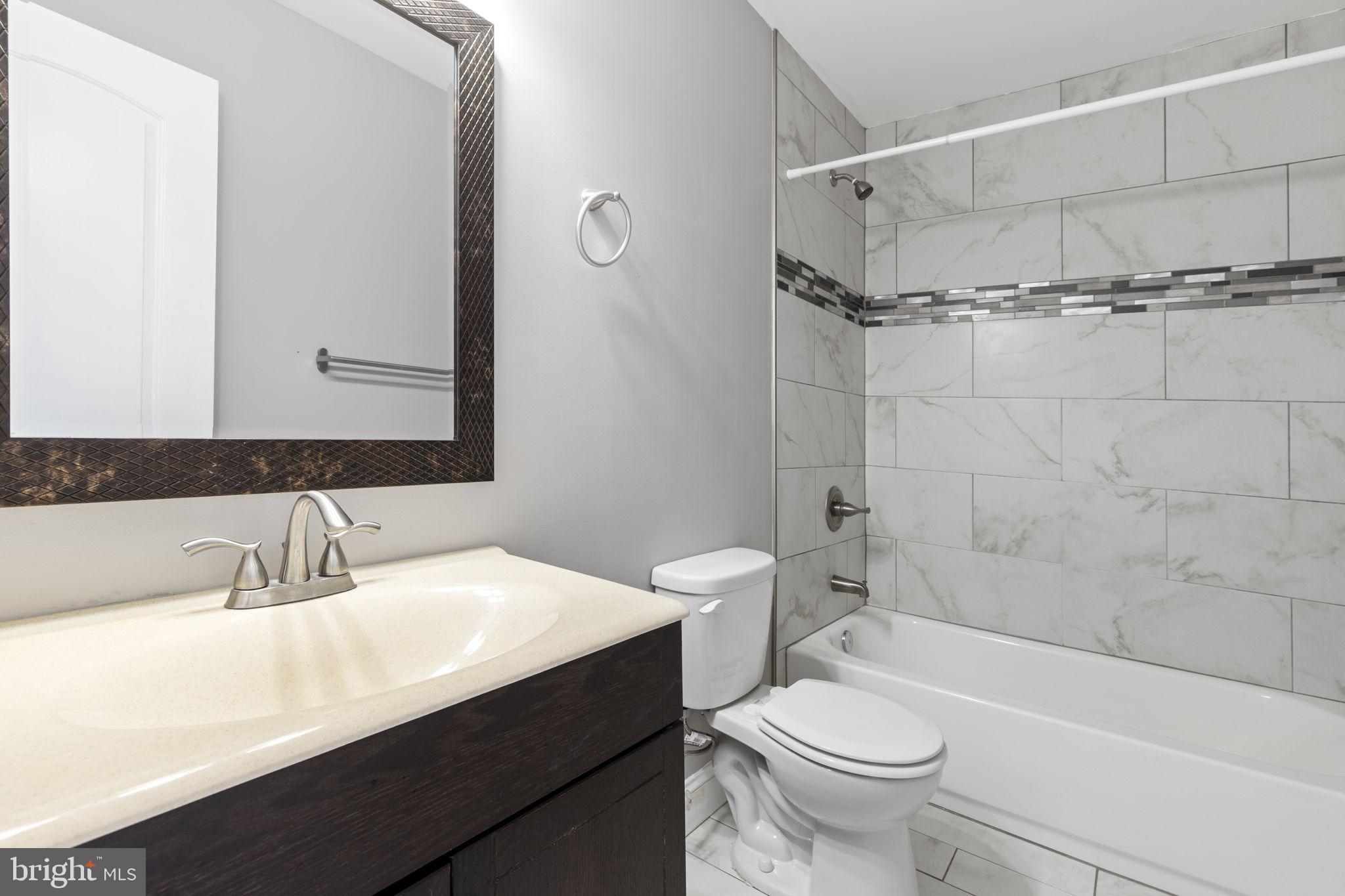 625 Savage Street Baltimore, MD 21224 - Photo 15 of 26 a bathroom with a sink a toilet and shower